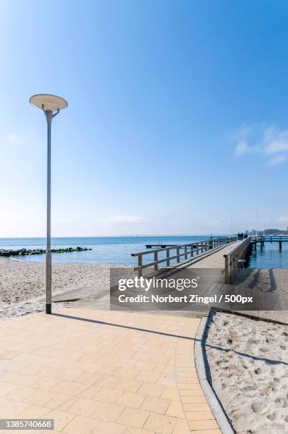 boardwalk by the sea,scenic view of beach against sky,juist,germany - promenade seafront stock pictures, royalty-free photos & images