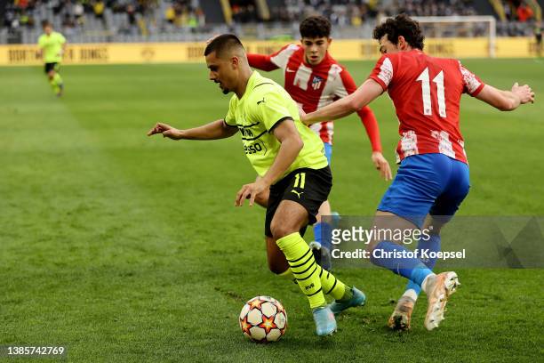 Adrian Corral Alciturri of Atletico Madrid challenges Lion Semic of Dortmund during the UEFA Youth League quarterfinal match between Borussia...