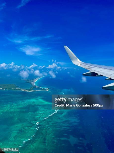 aerial view of sea against sky - plane wing stock pictures, royalty-free photos & images