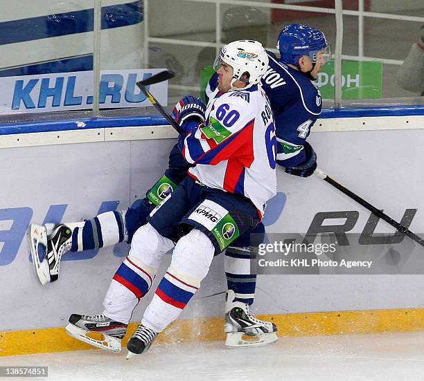 Tomas Rolinek of the Metallurg checks Alexander Boikov of the Dinamo into the boards during the KHL Championship 2011/2012 on January 14, 2012 at the...
