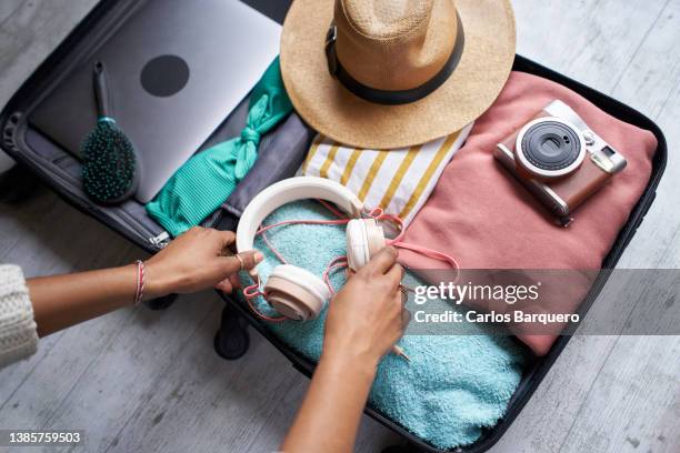 close up photo of black woman'l packing. - open suitcase stock pictures, royalty-free photos & images