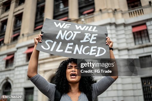 Woman holding signs during on a demonstration outdoors