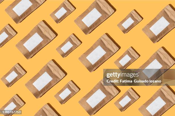 brown package with white label on yellow background - ordenado photos et images de collection