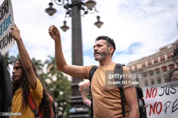 mature man during a demonstration in the street - male protestor stock pictures, royalty-free photos & images