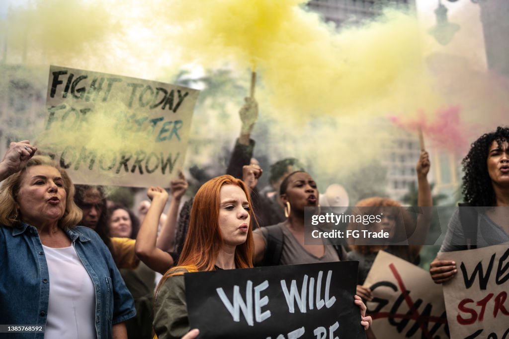 Protesters holding signs during a demonstration in the street