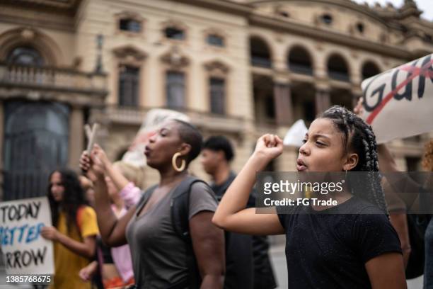 protesters during a demonstration in the street - social justice concept stock pictures, royalty-free photos & images
