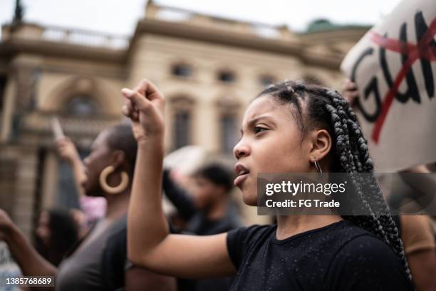 girl during a demonstration in the street - burgerrecht stockfoto's en -beelden