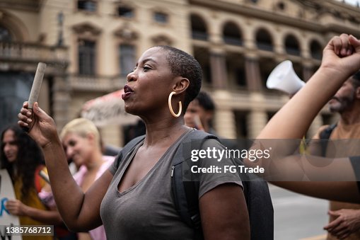 Mid adult woman during a demonstration in the street