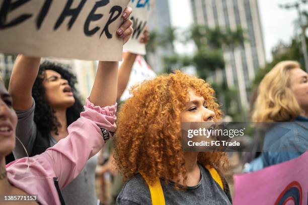 women on a demonstration for equal rights - feminism stock pictures, royalty-free photos & images