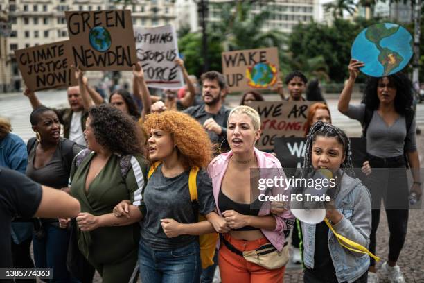 protesters on a demonstration for environmentalism - world democracy stock pictures, royalty-free photos & images