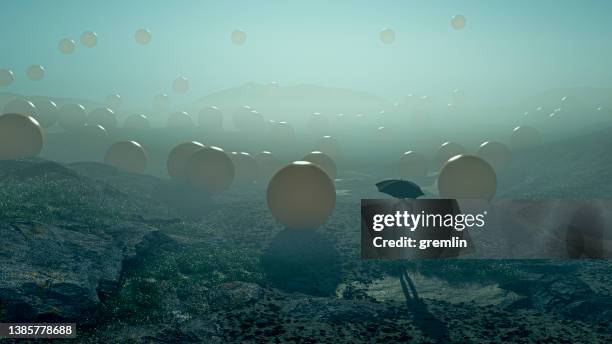 immagine surreale dell'uomo in piedi nel campo con sfere che cadono - out of context foto e immagini stock