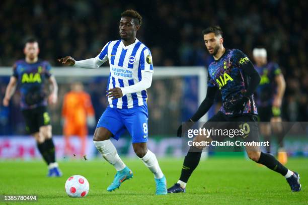 Yves Bissouma of Brighton & Hove Albion holds the ball whilst under pressure from Rodrigo Bentancur of Tottenham Hotspur during the Premier League...