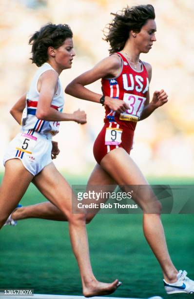 South African born athlete Zola Budd of Great Britain and American athlete Mary Decker compete in the final of the Women's 3000 Metres event at the...