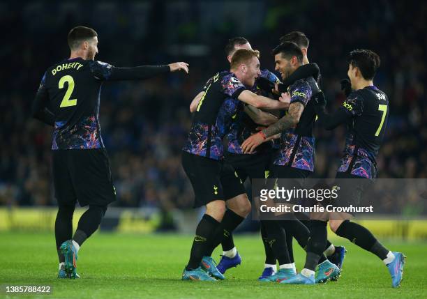 Cristian Romero of Tottenham Hotspur celebrates with teammates after scoring their team's first goal during the Premier League match between Brighton...