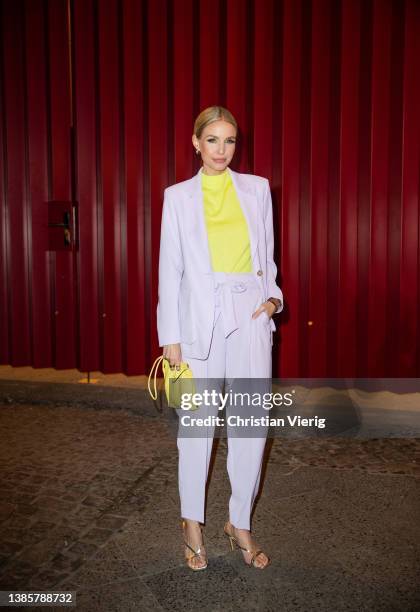 Leonie Hanne is seen wearing lavender blazer, pants, yellow bag, t shirt Marc Cain outside Marc Cain during Berlin Fashion Week on March 16, 2022 in...