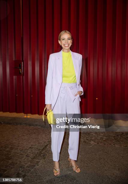 Leonie Hanne is seen wearing lavender blazer, pants, yellow bag, t shirt Marc Cain outside Marc Cain during Berlin Fashion Week on March 16, 2022 in...