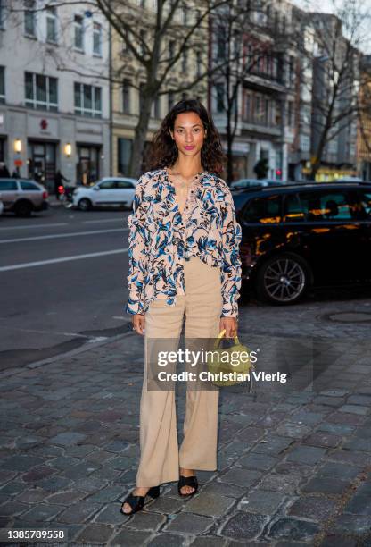 Lani Lees is seen wearing blouse with print, beige pants, yellow bag, heels Marc Cain outside Marc Cain during Berlin Fashion Week on March 16, 2022...