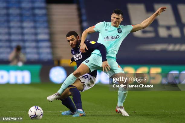 Mason Bennett of Millwall and Matty Pearson of Huddersfield Town battle for the ball during the Sky Bet Championship match between Millwall and...