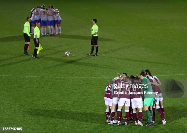 Both teams huddle prior to the Barclays FA Women's Super League match between West Ham United Women and Manchester United Women at Chigwell...