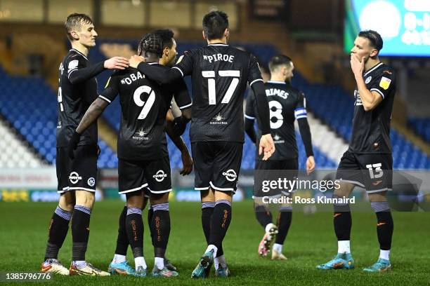 Michael Obafemi of Swansea City celebrates their sides first goal with team mates during the Sky Bet Championship match between Peterborough United...