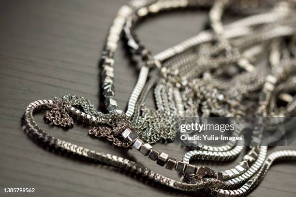 pile of assorted silver chains - choker necklace stock pictures, royalty-free photos & images