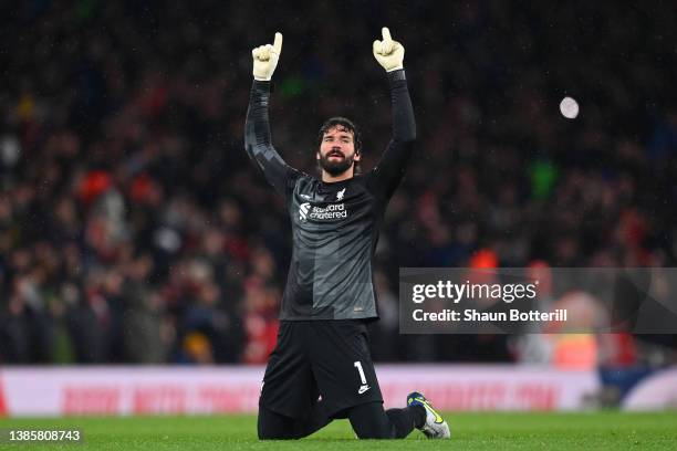 Alisson Becker of Liverpool celebrates their sides first goal scored by team mate Diogo Jota during the Premier League match between Arsenal and...