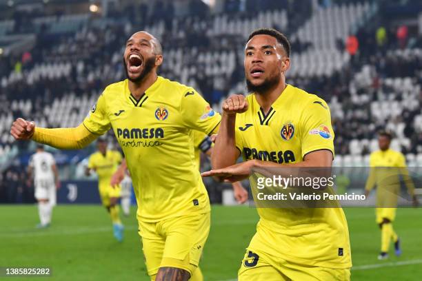 Arnaut Danjuma of Villarreal CF celebrates their sides third goal with team mate Etienne Capoue during the UEFA Champions League Round Of Sixteen Leg...