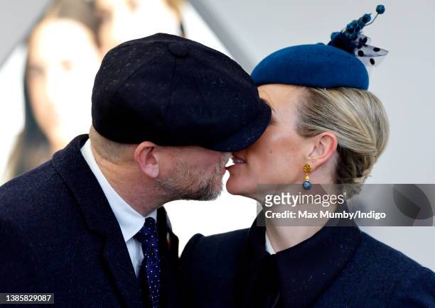 Mike Tindall and Zara Tindall kiss as they attend day 2 'Ladies Day' of the Cheltenham Festival at Cheltenham Racecourse on March 16, 2022 in...