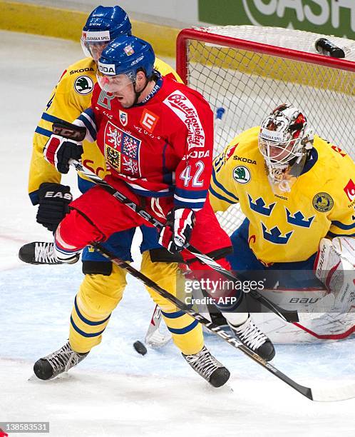 Czech Republic's Petr Koukal jumps over the puck in front of Sweden's goalkeeper Johan Gustafsson during the Oddset Hockey games ice hockey match...