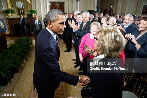 President Barack Obama shakes hands with audience members after delivering remarks on the No Child Left Behind law in the East Room of the White...