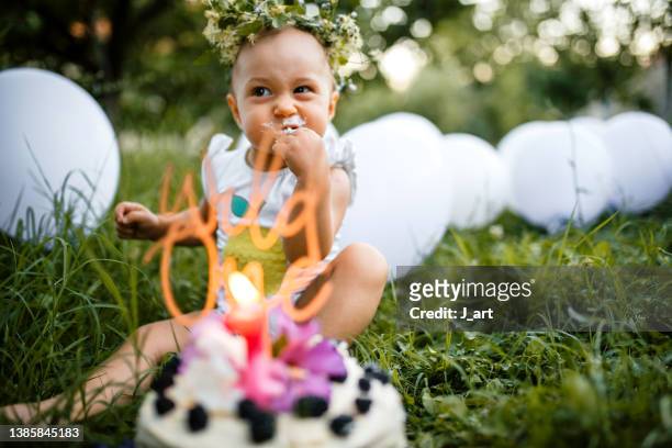 the first bite of birthday cake. - eerste verjaardag stockfoto's en -beelden