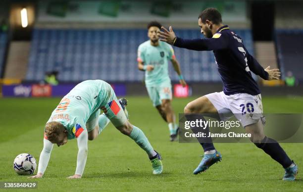 Lewis O'Brien of Huddersfield Town is challenged by Mason Bennett of Millwall during the Sky Bet Championship match between Millwall and Huddersfield...