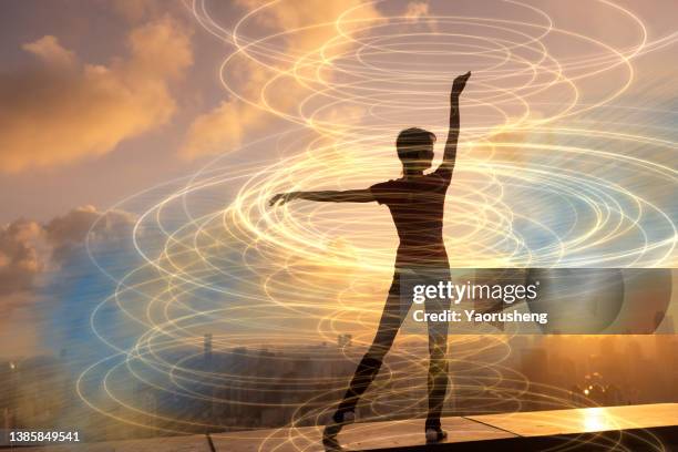 young happy woman dancing with ribbons in the beautiful sunset,morden city background - woman ribbon happy stockfoto's en -beelden