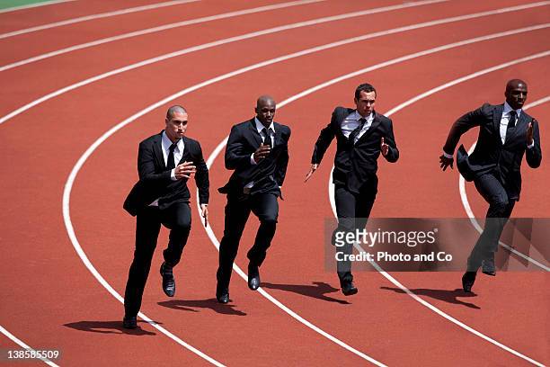 businessmen runnin g on track - competizione foto e immagini stock