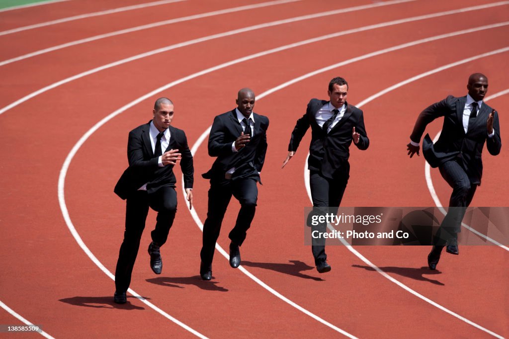 Businessmen runnin g on track