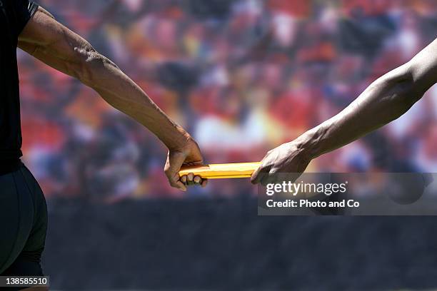 two male runners passing baton - passing sport stock pictures, royalty-free photos & images