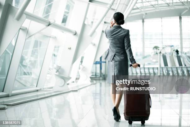 businesswoman in airport - black hair back stock pictures, royalty-free photos & images