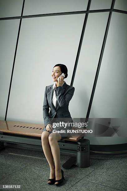 businesswoman in airport - skirt suit stock-fotos und bilder