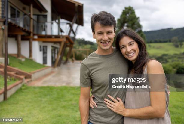 loving couple outside their house in the countryside - smiling natural woman countryside stock pictures, royalty-free photos & images