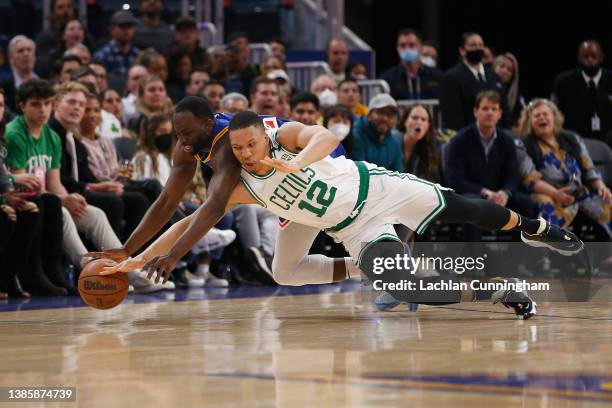Grant Williams of the Boston Celtics competes for a loose ball against Draymond Green of the Golden State Warriors in the first quarter at Chase...