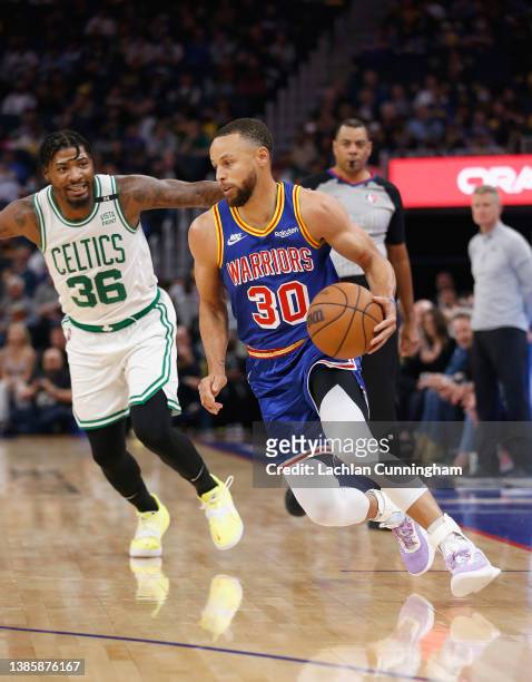 Stephen Curry of the Golden State Warriors drives to the basket against Marcus Smart of the Boston Celtics in the first quarter at Chase Center on...