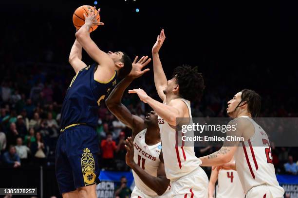 Paul Atkinson Jr. #20 of the Notre Dame Fighting Irish shoots the game winning basket in the second overtime to defeat the Rutgers Scarlet Knights...