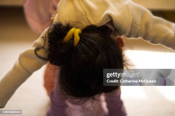 older sister holds younger sister in air for fun game of “airplane” - girls wrestling stock pictures, royalty-free photos & images