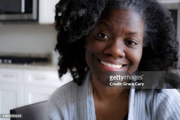 contented mid adult black woman - big hair stock pictures, royalty-free photos & images
