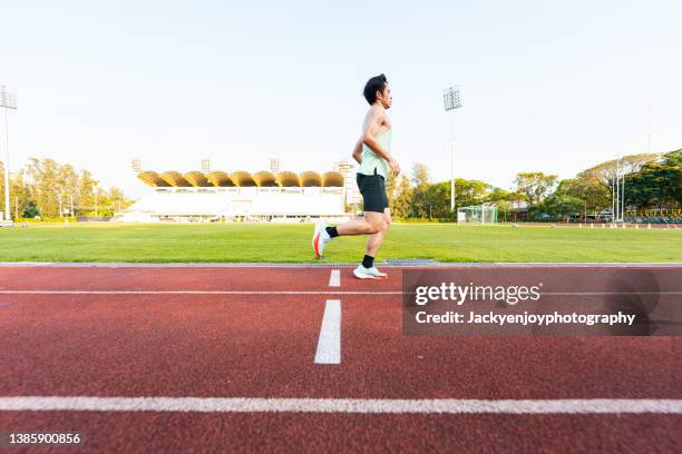 runner on tartan track starting - single track stock pictures, royalty-free photos & images