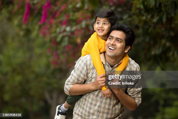 father with son admiring view at park - father son admiration stock pictures, royalty-free photos & images