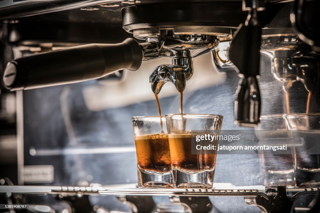 Espresso shot from the espresso machine with the mixed lighting of ambient and flash light