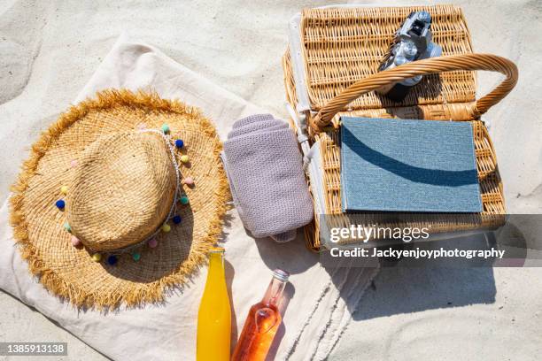 beach bag with accessories at the beach - beach bag stock pictures, royalty-free photos & images