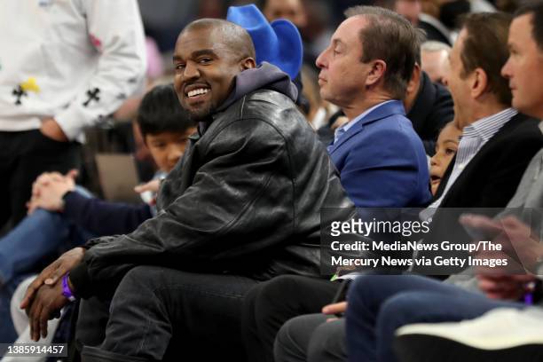 Kanye West, left, and his son, Saint West, got front row seats next to Golden State Warriors co-owners Joe Lacob and Peter Guber as they watch the...