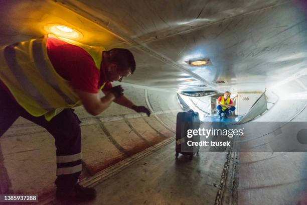 airport service crew unloading luggage - airport cargo stock pictures, royalty-free photos & images